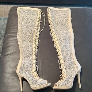 Lace up cream boots with the zipper in the back